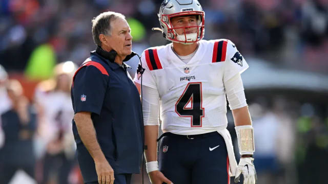 New England Patriots Bill Belichick speaks with quarterback Bailey Zappe